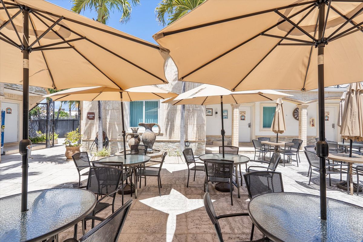 Tables under the palms at Hollywood Beach Hotels